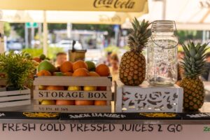 Vibrant display of fresh fruits and pineapples at an outdoor juice bar in Split, Croatia.