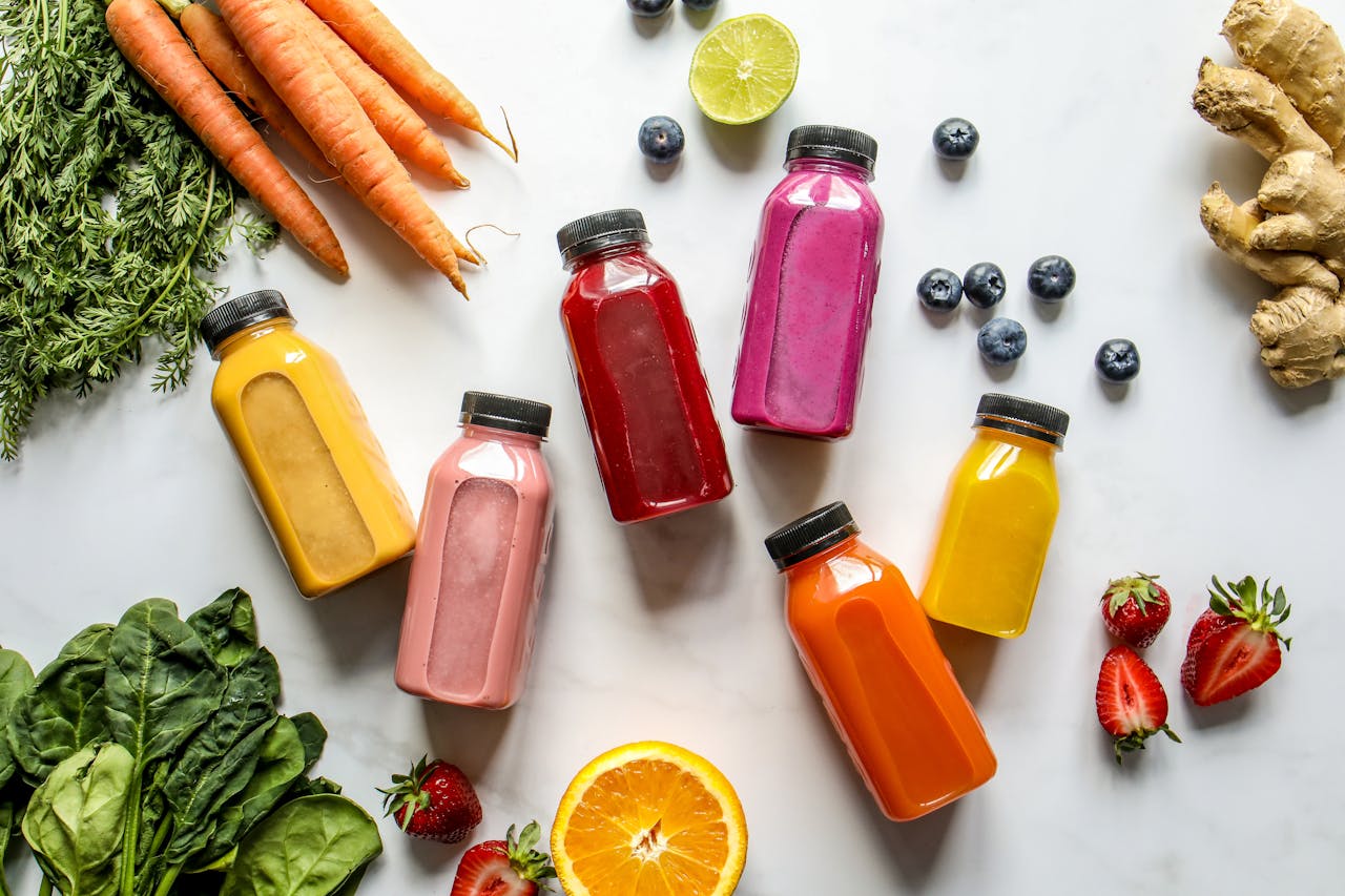 Colorful assortment of organic juices with fresh ingredients for a healthy lifestyle.